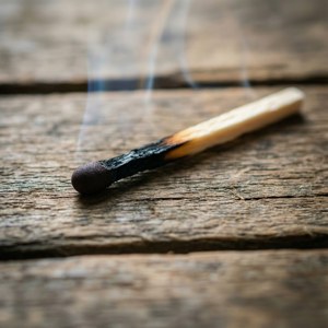 Burnt Matchstick on Wood