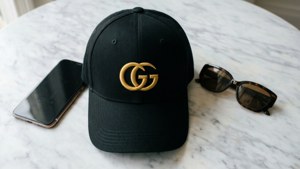 Flat Lay Gucci Cap and Accessories
