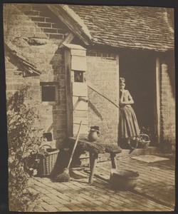 [Girl in farmhouse doorway]