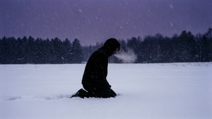 Kneeling Figure in Snowfield