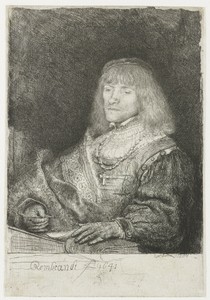 Man at a desk wearing a cross and chain