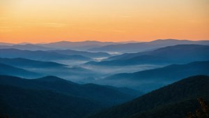 Misty Sunrise Over Ridges