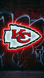 Neon Arrowhead on Brick