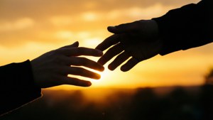 Reaching Hands at Sunset