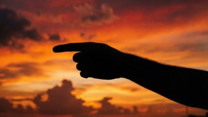Silhouette Pointing at Sunset