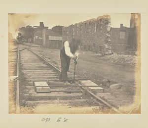 [Straightening bent rails with a jackscrew]