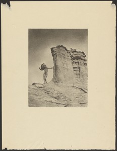 [Woman in Indian Costume in the Desert Posed Next to a Large Rock Formation]
