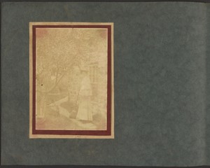 [Woman with Broom in Garden]